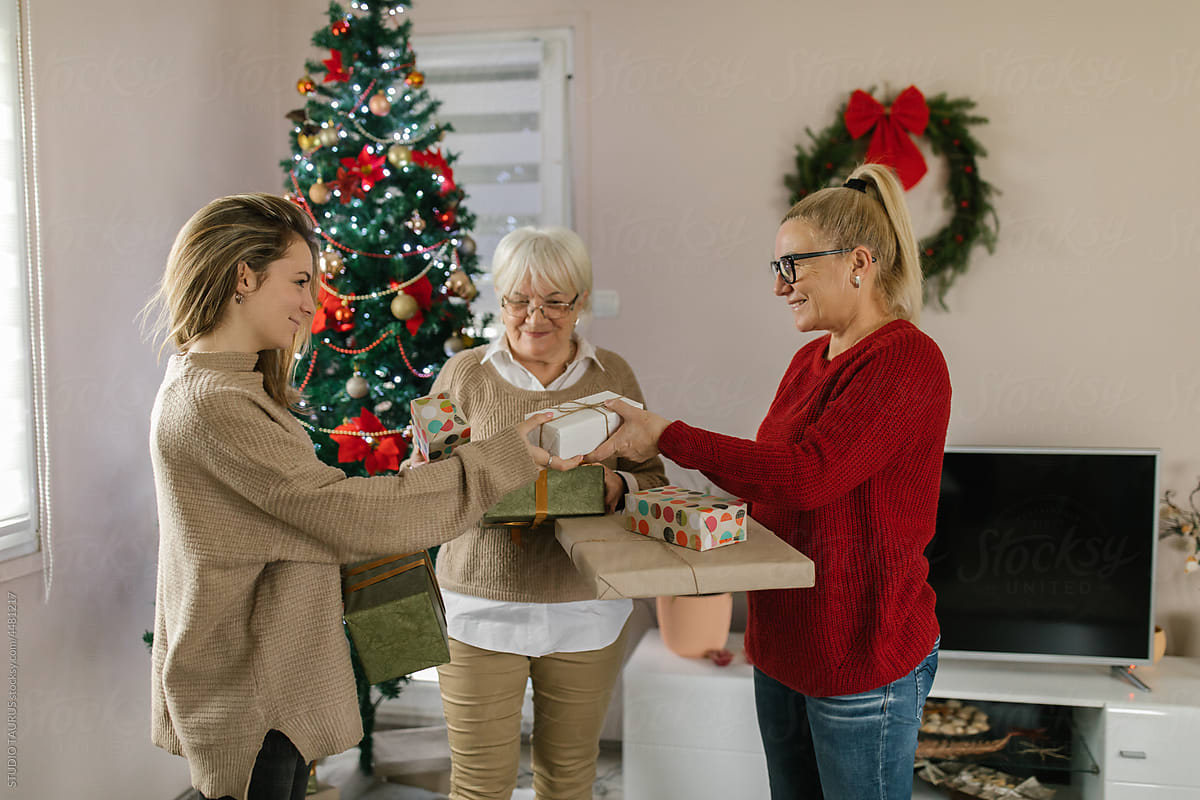 Caucasian family exchanging Christmas presents at home