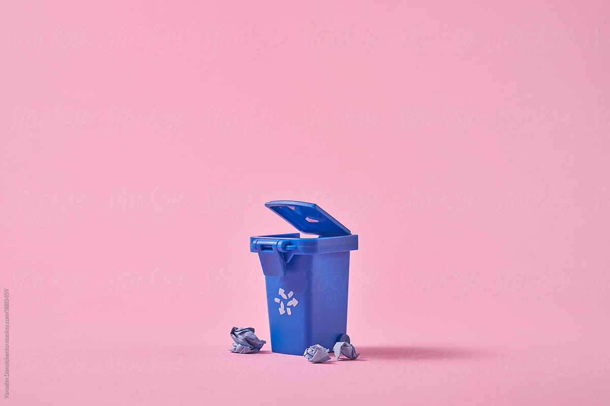 Blue dumpster and crumpled paper