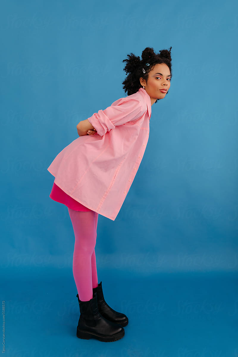 Black woman in pink outfit leaning forward
