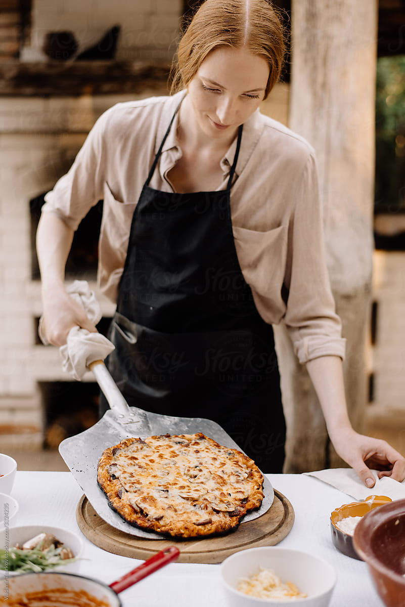 woman chef serving homemade pizza