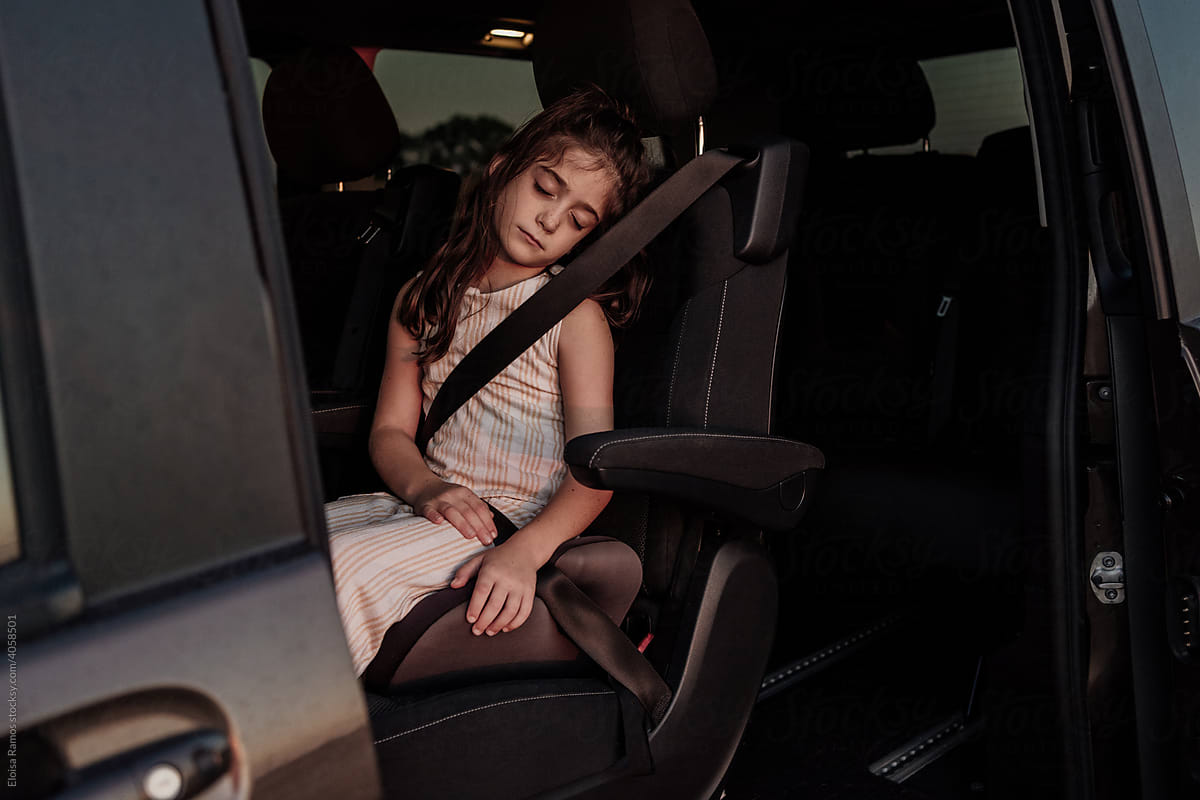 Girl sleeping sitting in a car
