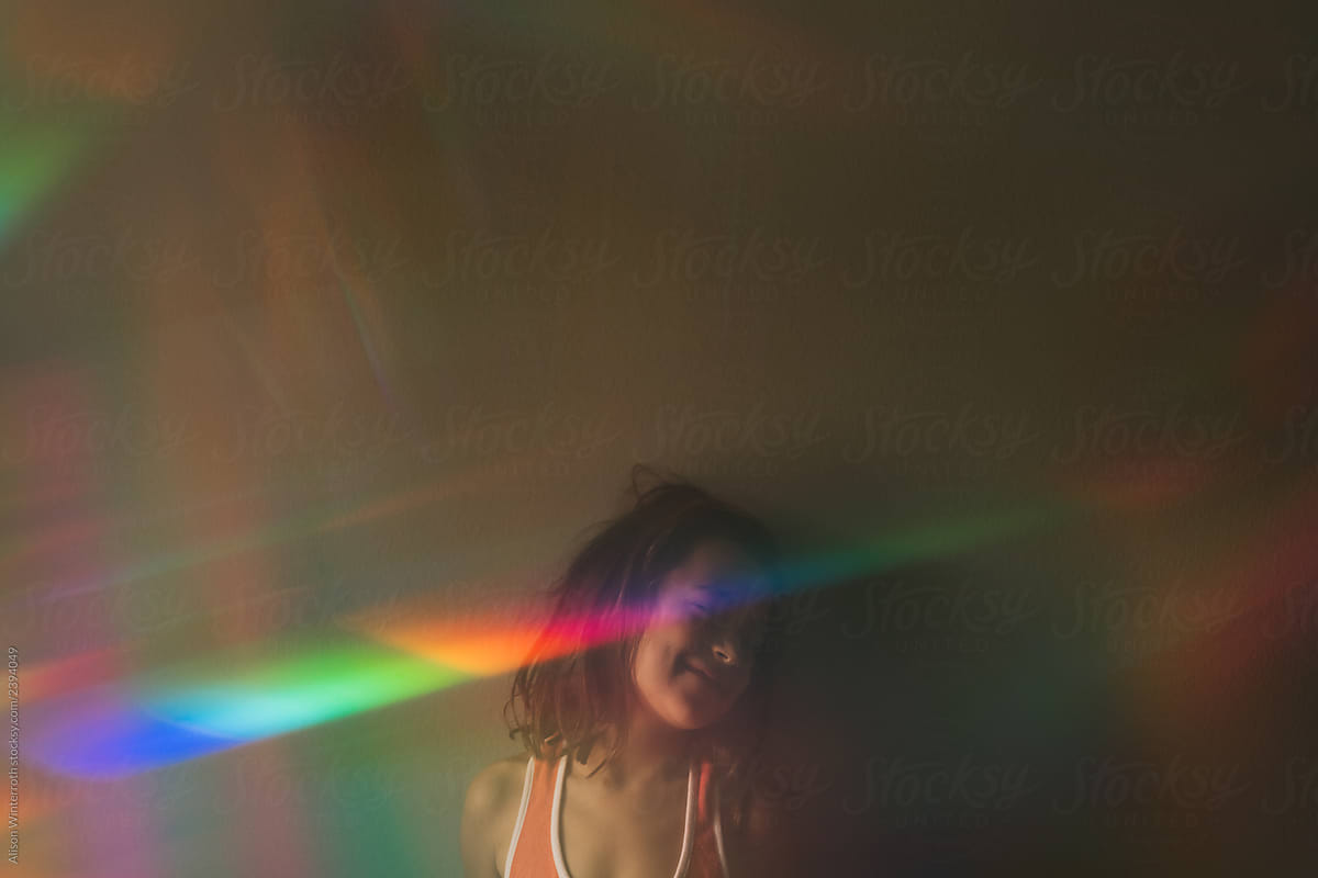 A Happy Girl With A Rainbow Across Her Face and Messy Hair