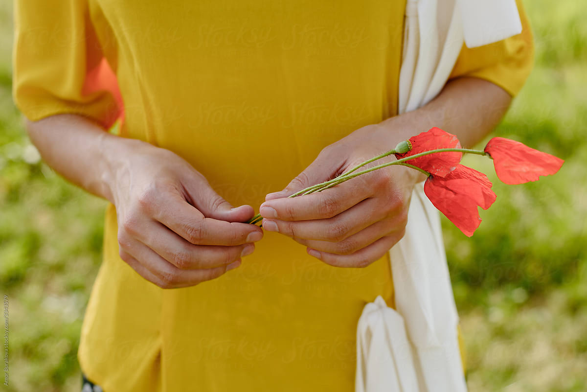 Woman holding poppy flowers
