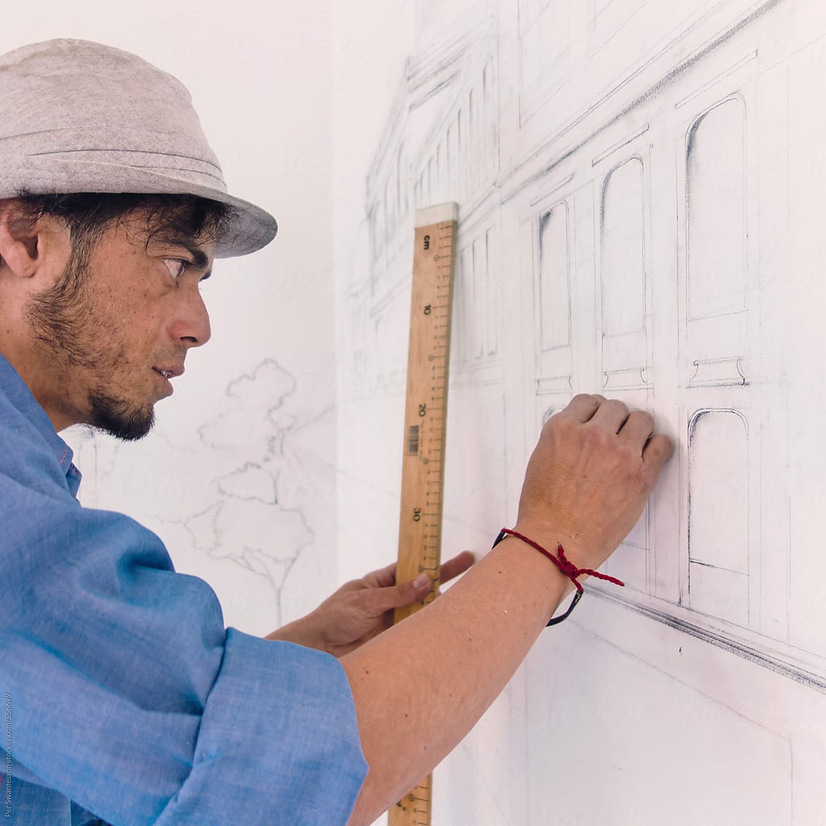 Closeup of concentrated hispanic artist drawing a wall mural