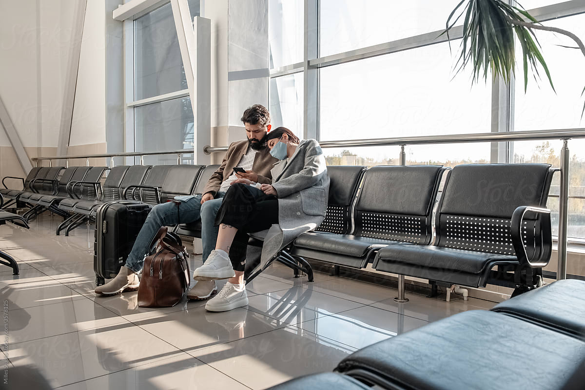 Tired couple waiting for flight in airport
