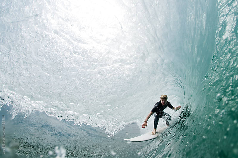 surfer riding a barreling wave