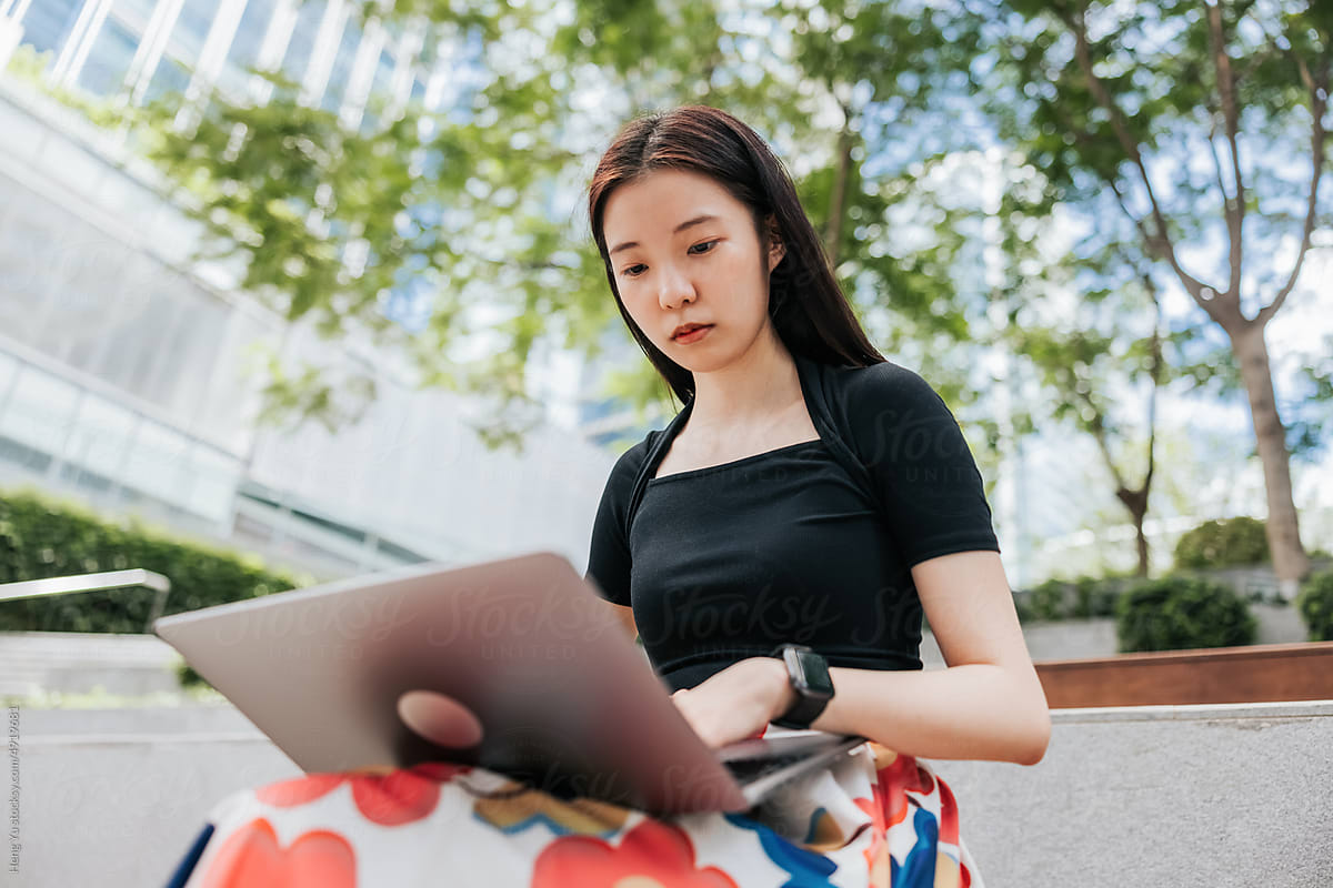Businesswoman  working on a laptop outdoor