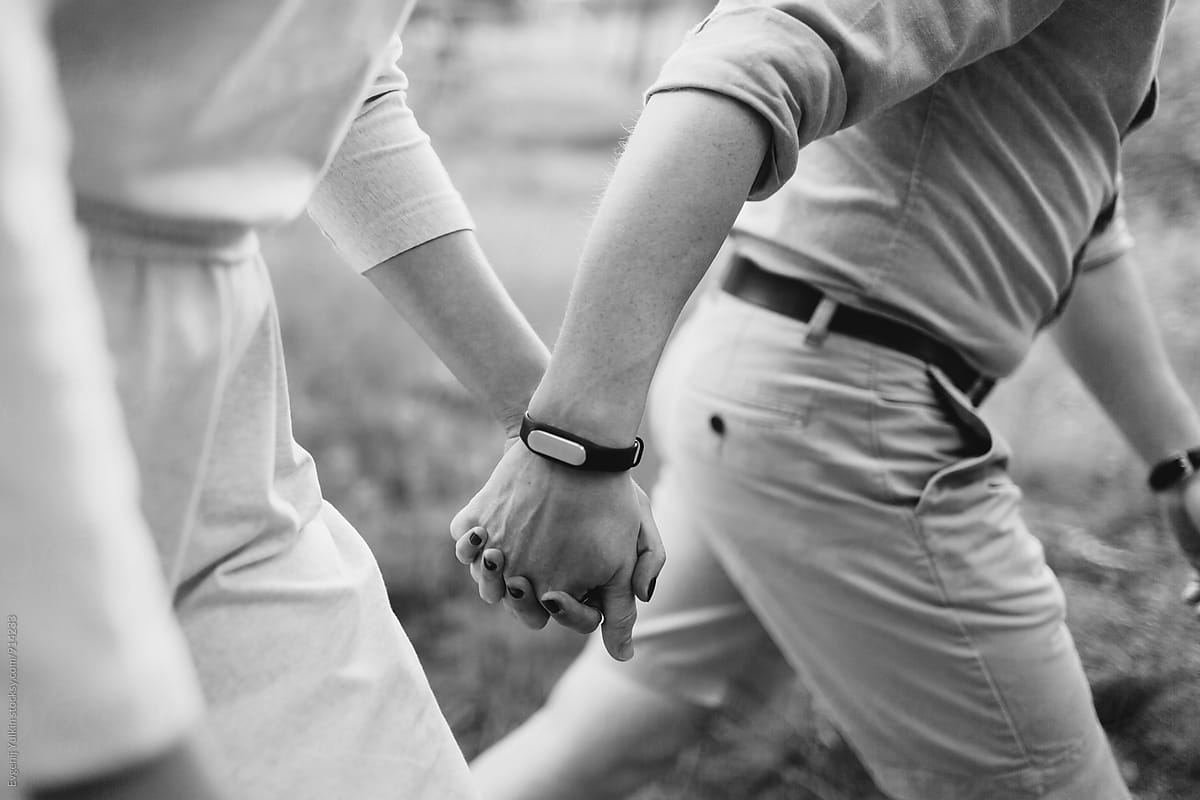 Couple holding hands close-up