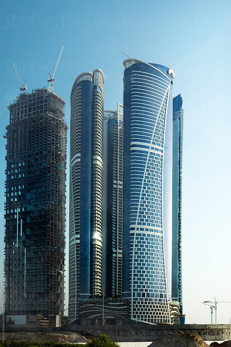 Urban development in Dubai, an unfinished project next to a finished apartment building
