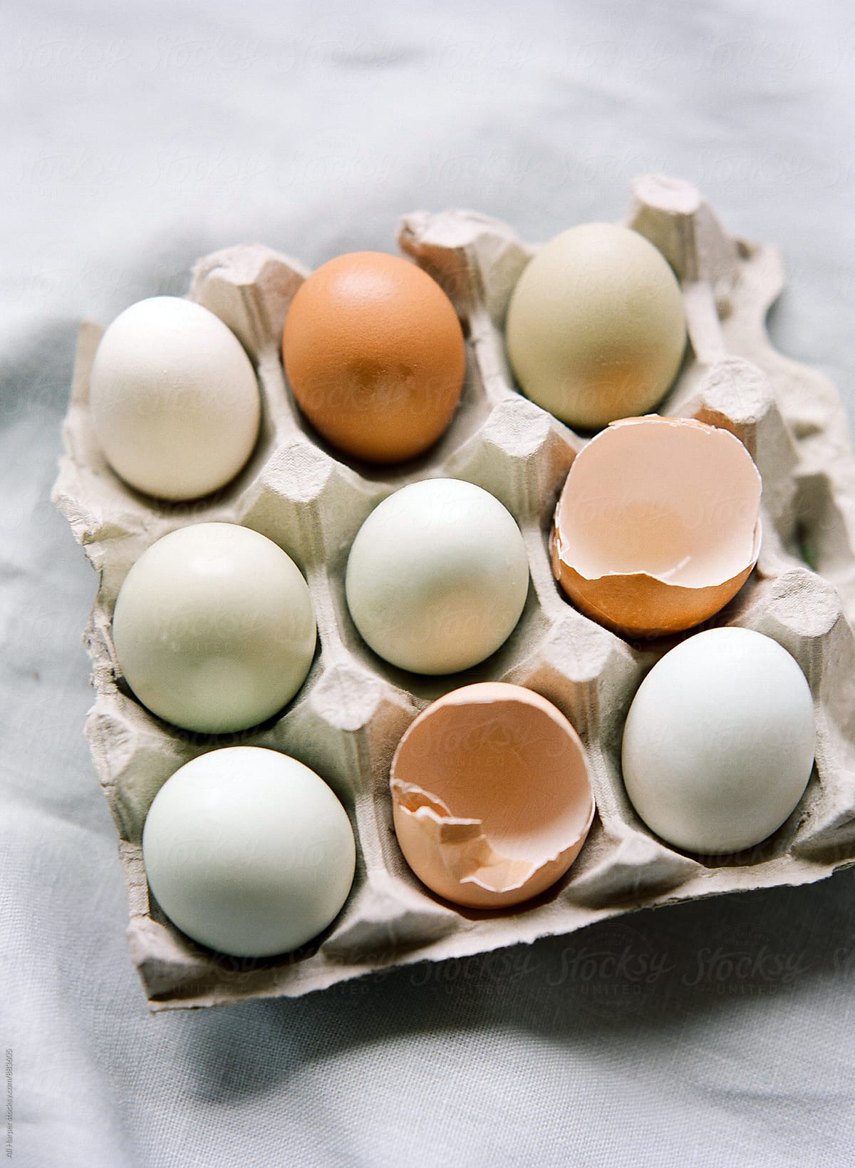 Nine eggs in carton on table