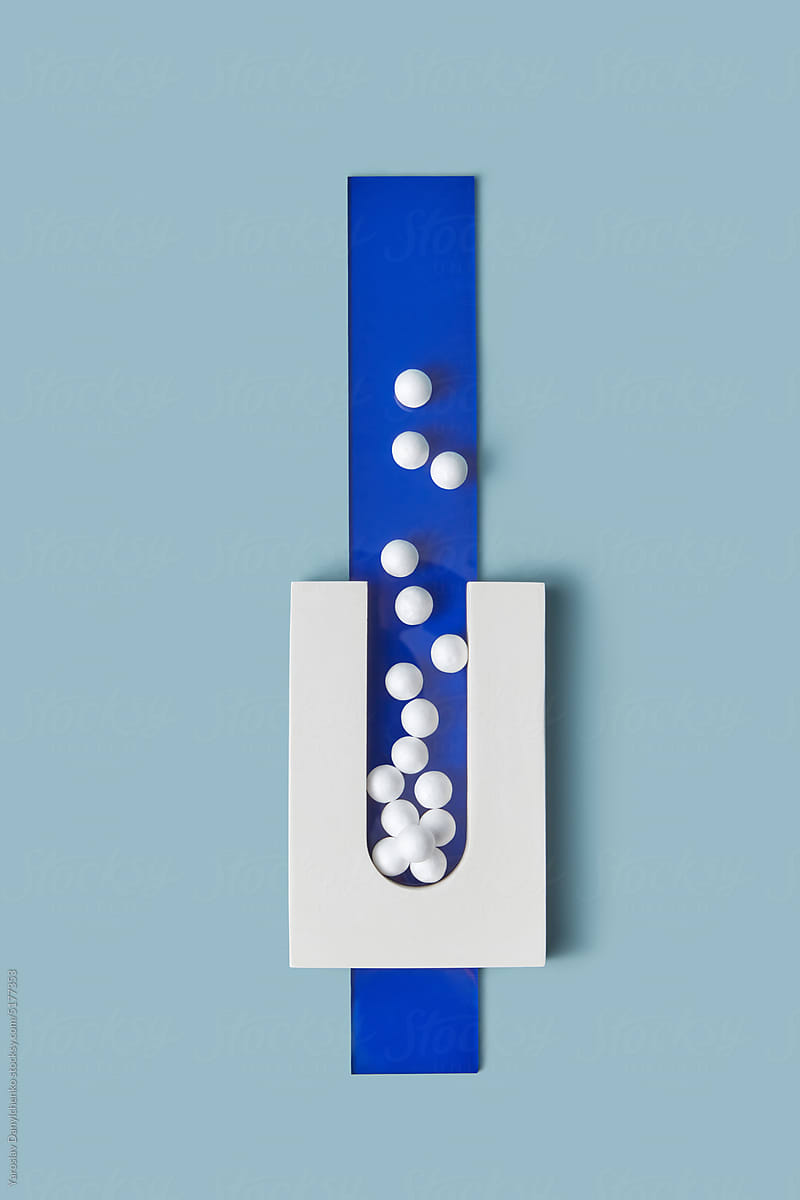 White cement element with balls on blue glass.