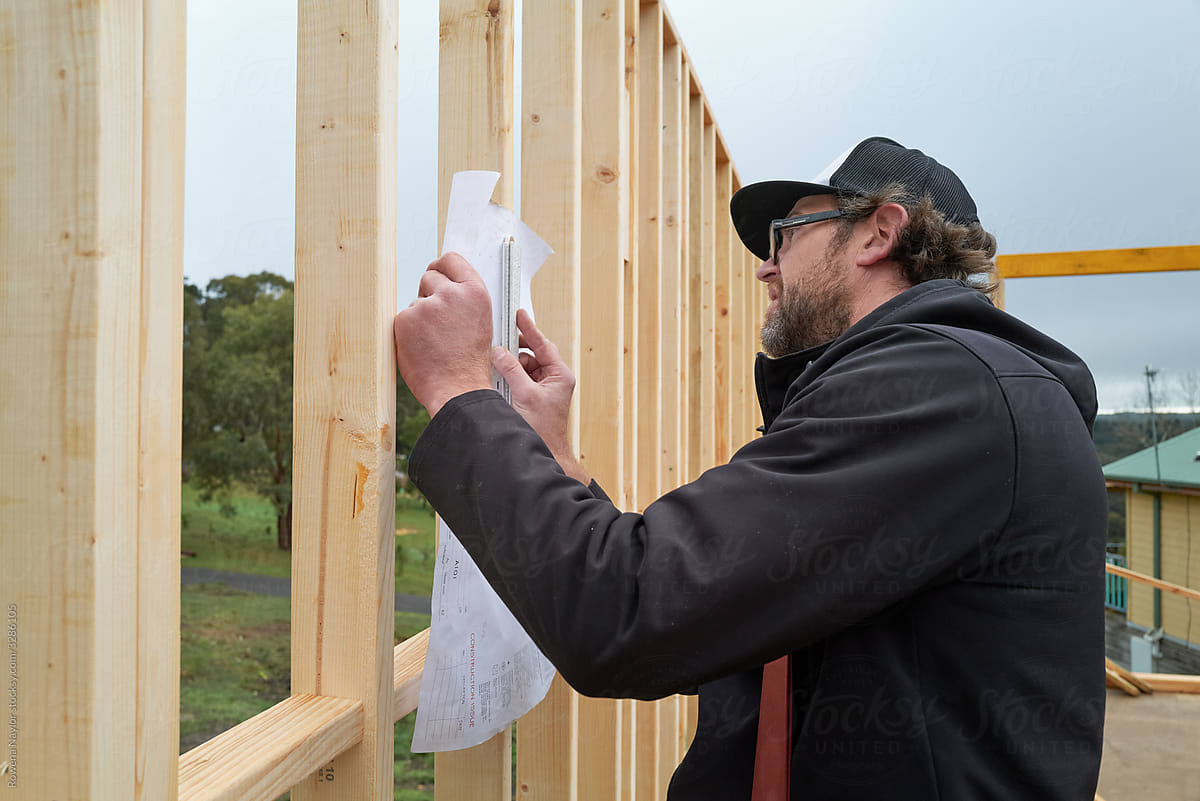 Builder looking at architectural drawing onsite