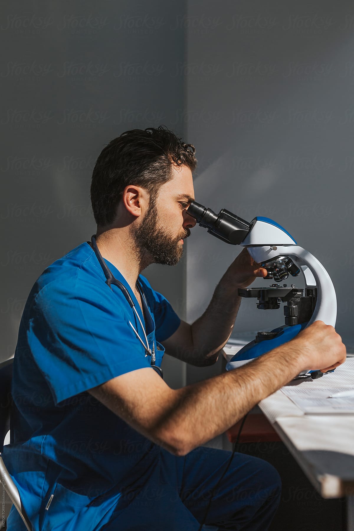 Veterinary working with a microscope and taking notes