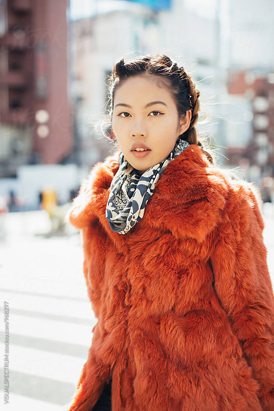Portrait of Pretty and Fashionable Young Japanese Woman Standing in Tokyo Street