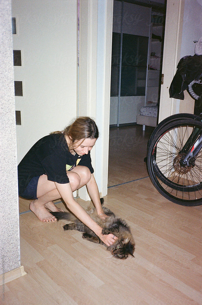 UGC. Home style photo young woman cuddles her cat
