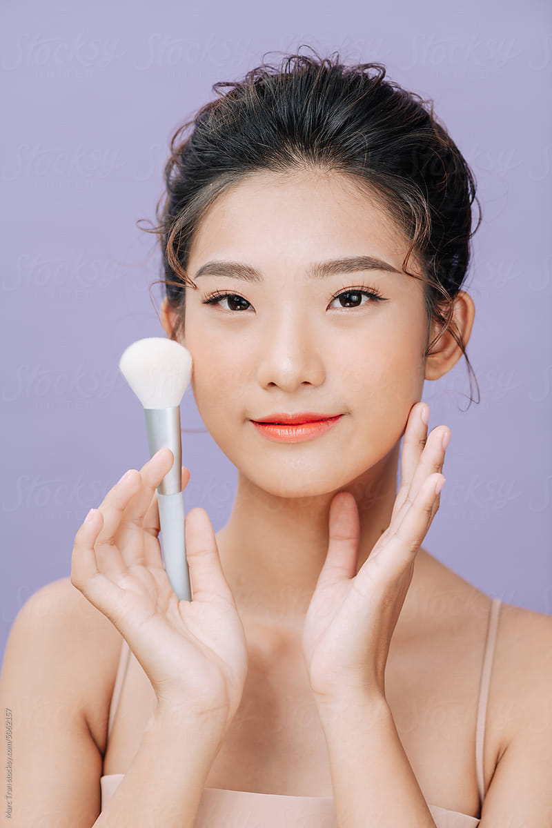 asian young pretty woman lady girl female applying brush makeup