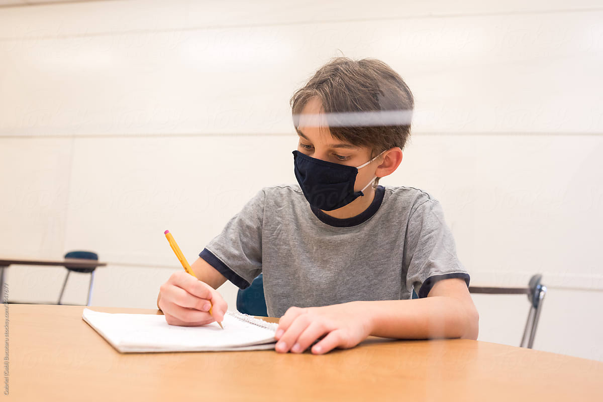Boy with mask in a classroom