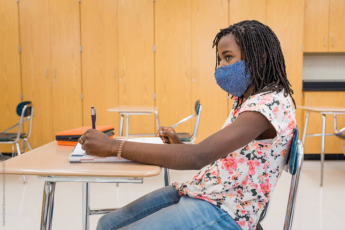 Black girl with mask in the classroom during COVID-19