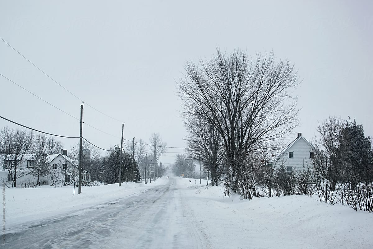 Country road  with farms during a snow storm