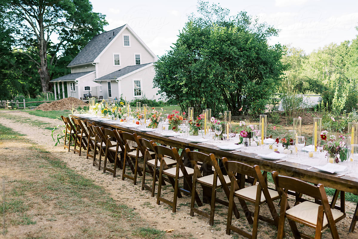 View of a long event table with decor and flower arrangements