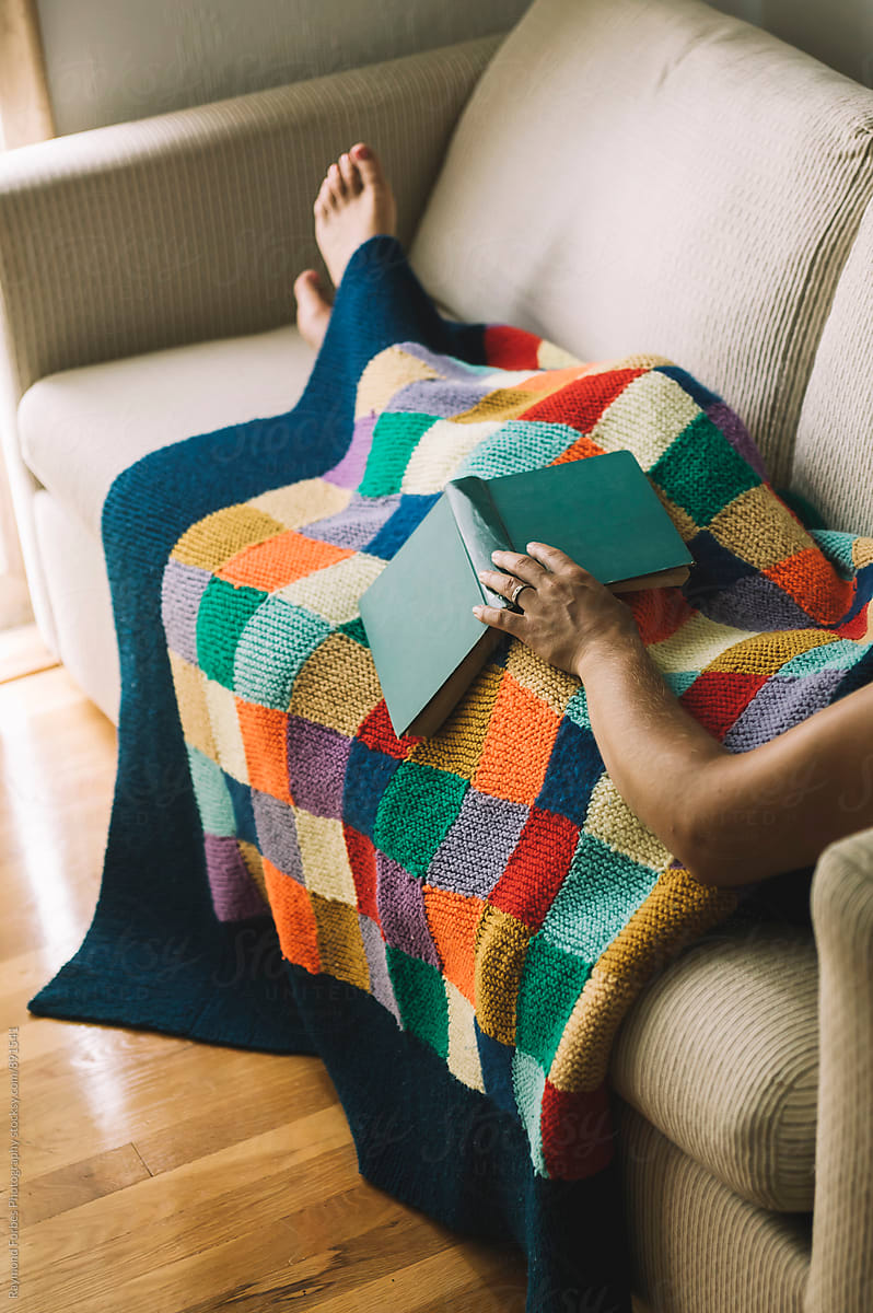 Woman reading book with Cozy Blanket