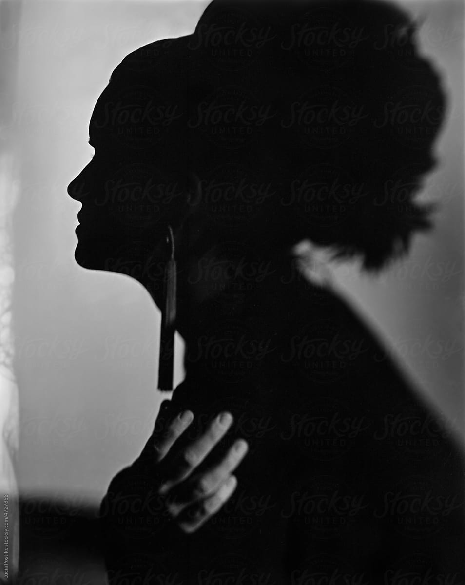 Silhouette of a woman with lush hair in profile.