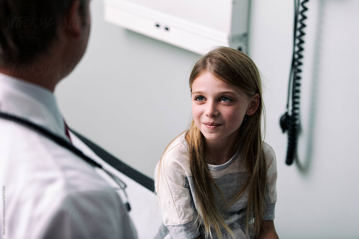 Exam: Girl Patient Listening To Doctor
