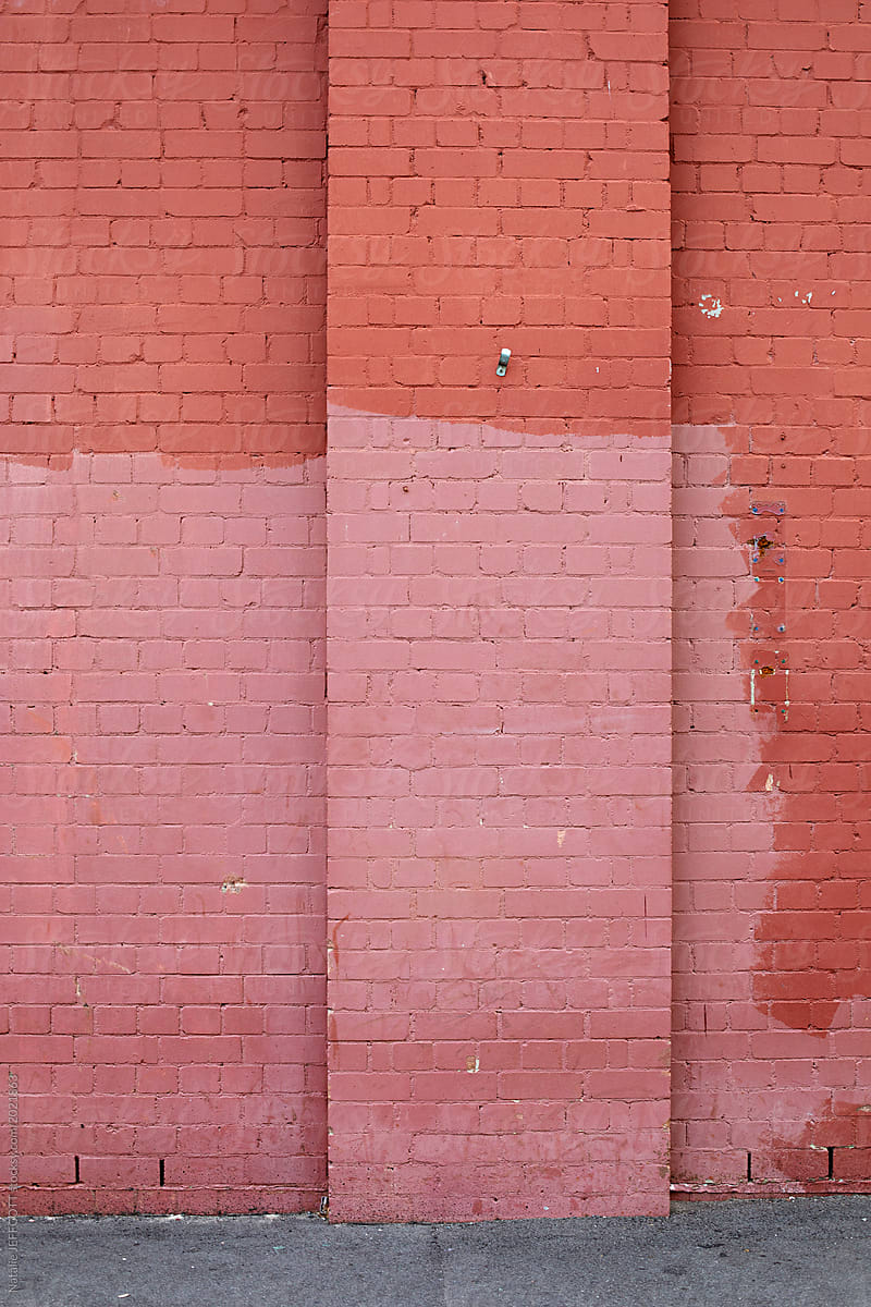 Badly matched pink coloured paint on a brick wall in Sydney