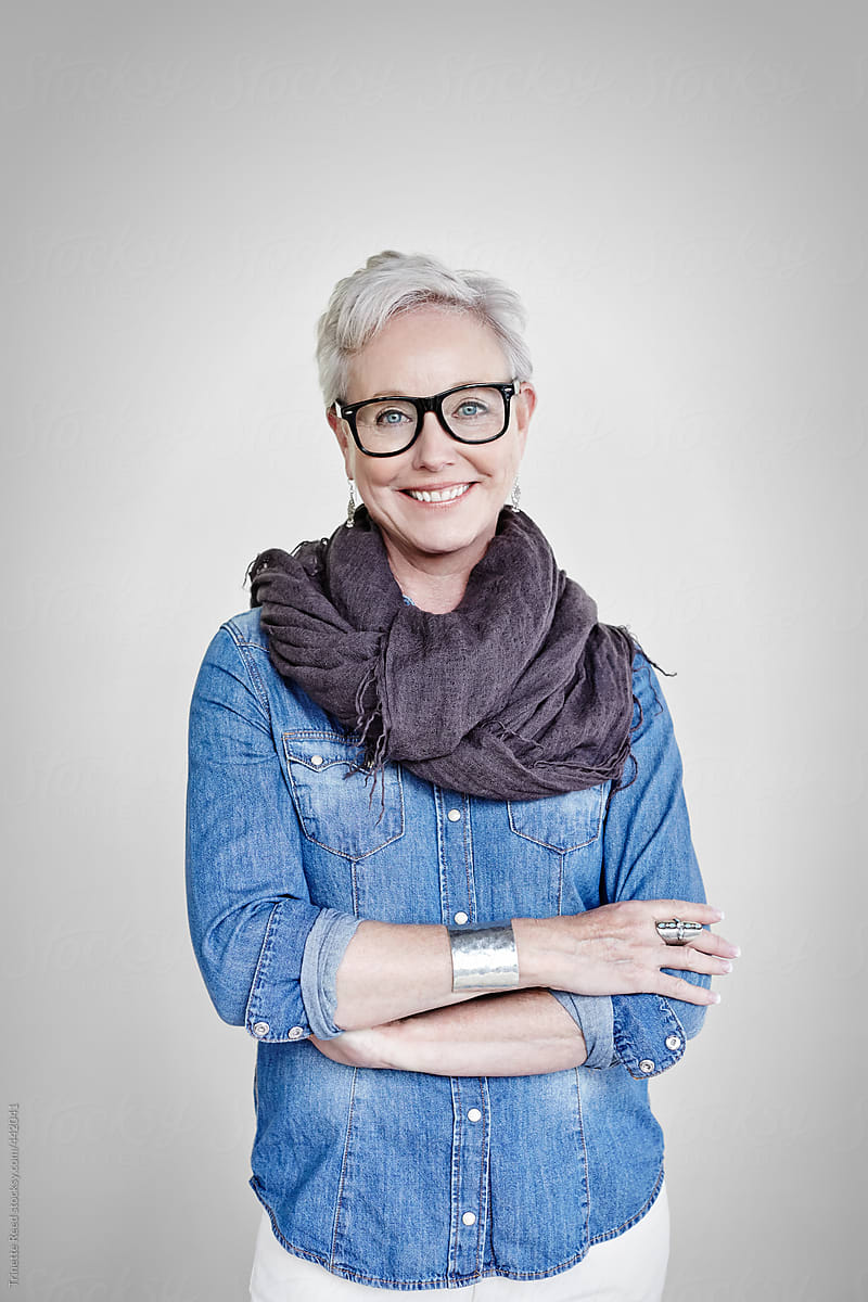 Studio portrait of happy mature woman with grey hair