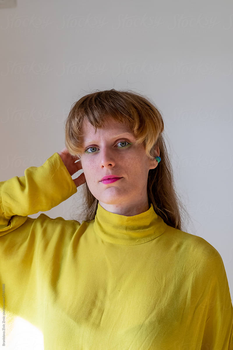 Portrait of a female model in a bright yellow blouse