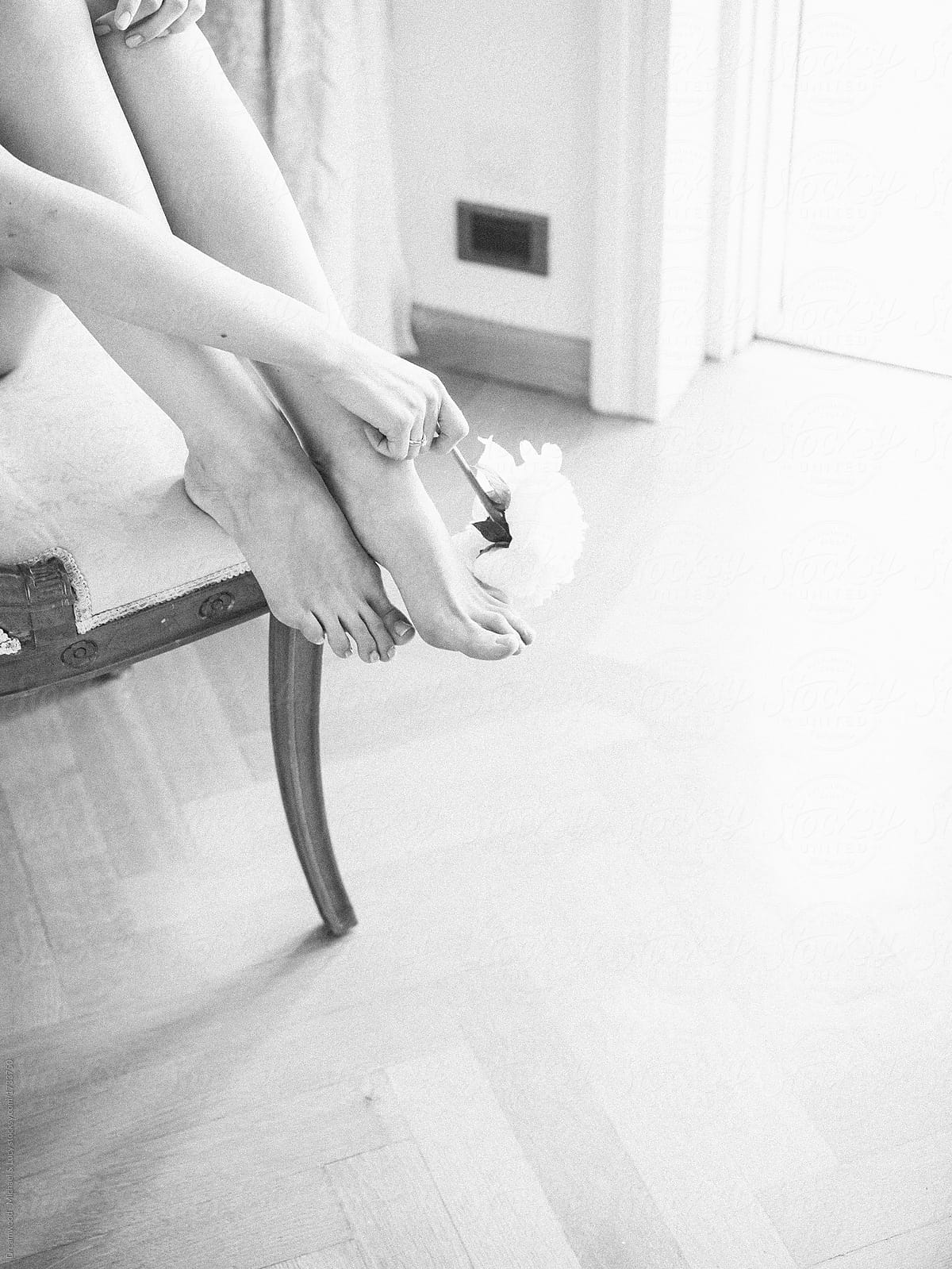 Crop gentle woman posing barefoot