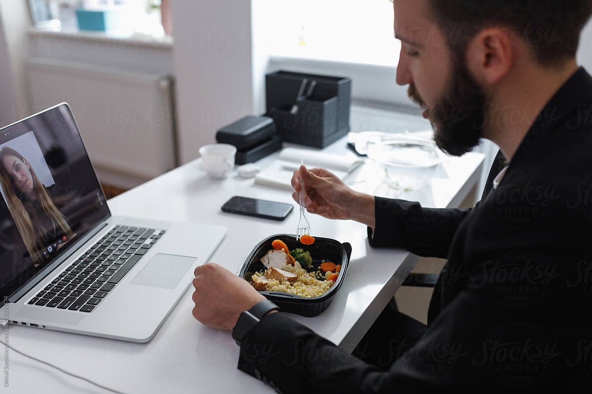 Employee having lunch during online meet