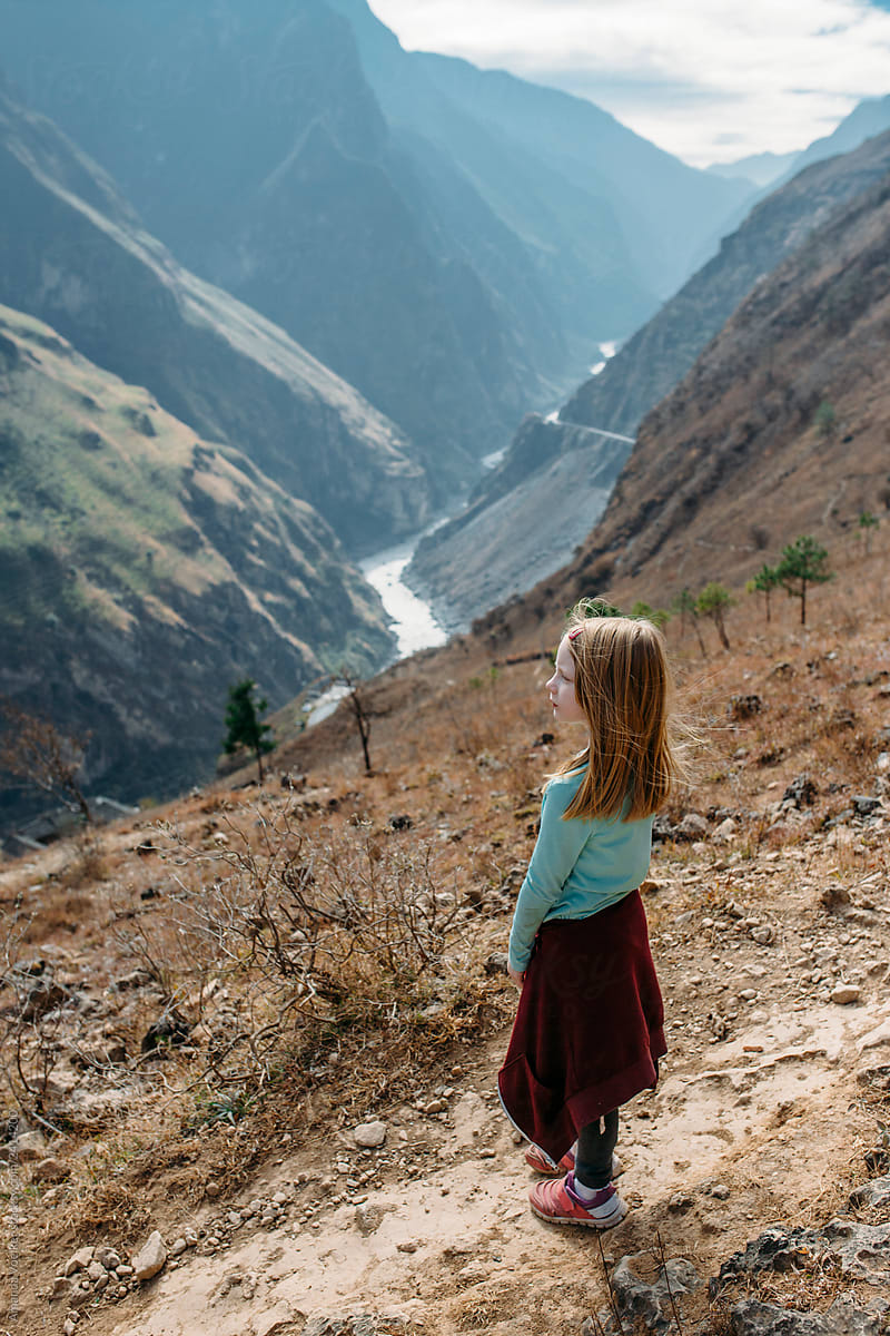 Back view of Young Girl Hiking on a high mountain pass