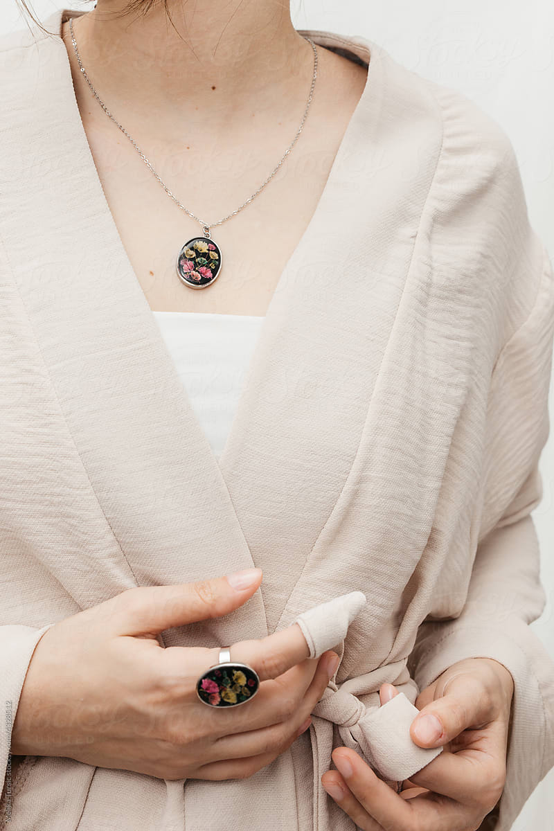 woman wearing floral epoxy necklace and ring
