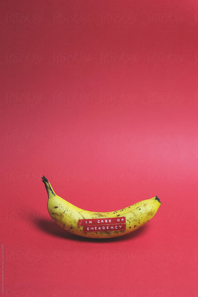 A banana labeled with a sticker  \'In case of emergency\'