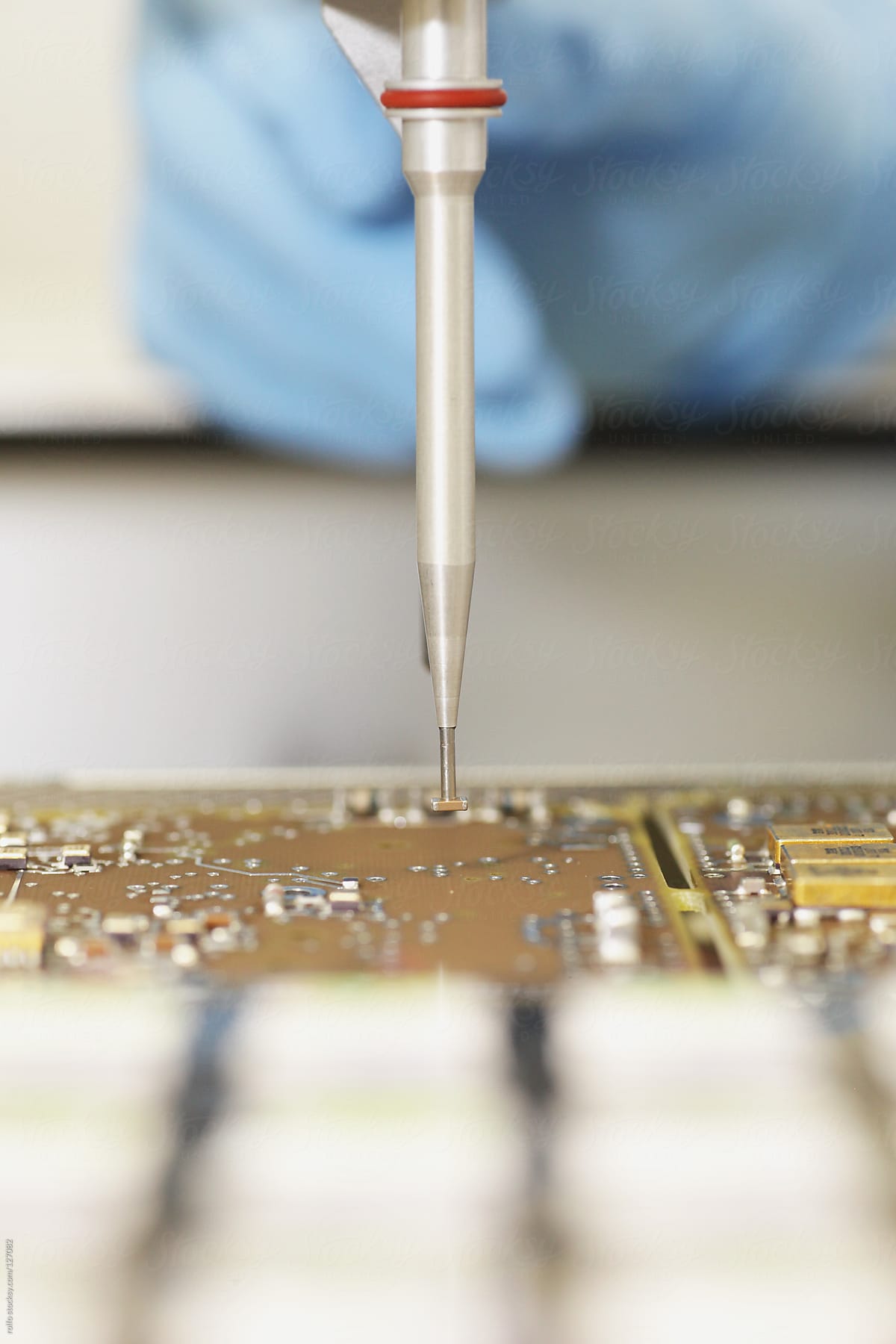 Technician soldering an electronics circuit board