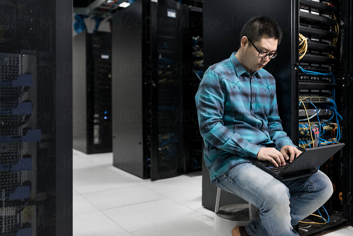 Young engineer working in datacenter