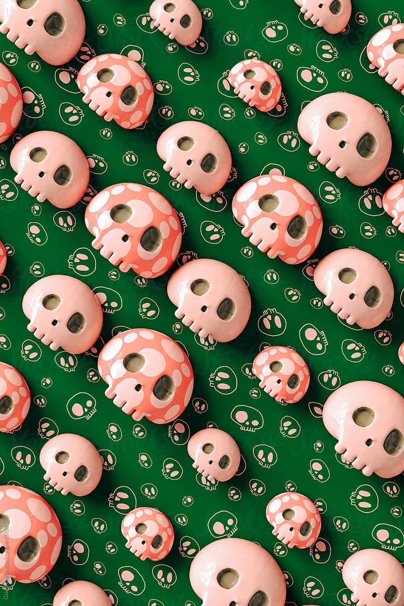 Pink skulls on green background