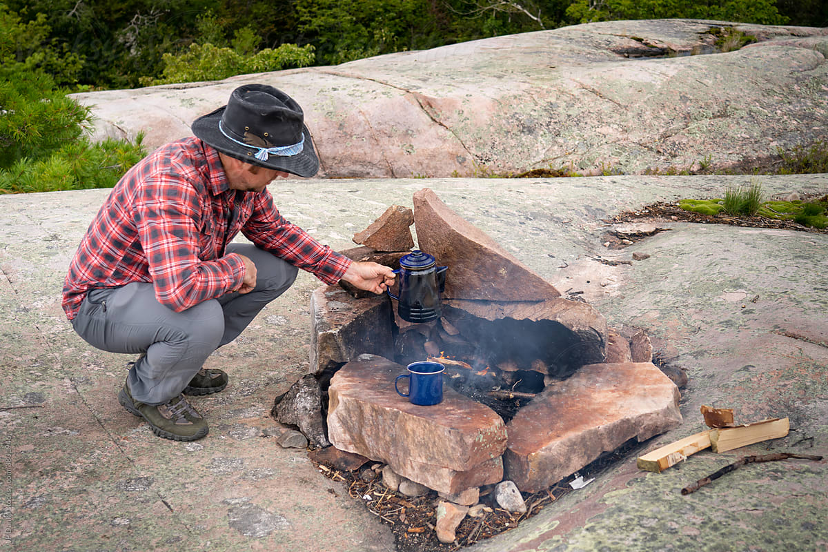 Man Preparing Coffee on Wildernes Kayak Camping Trip to Georgian Bay Killarney Ontario Canada