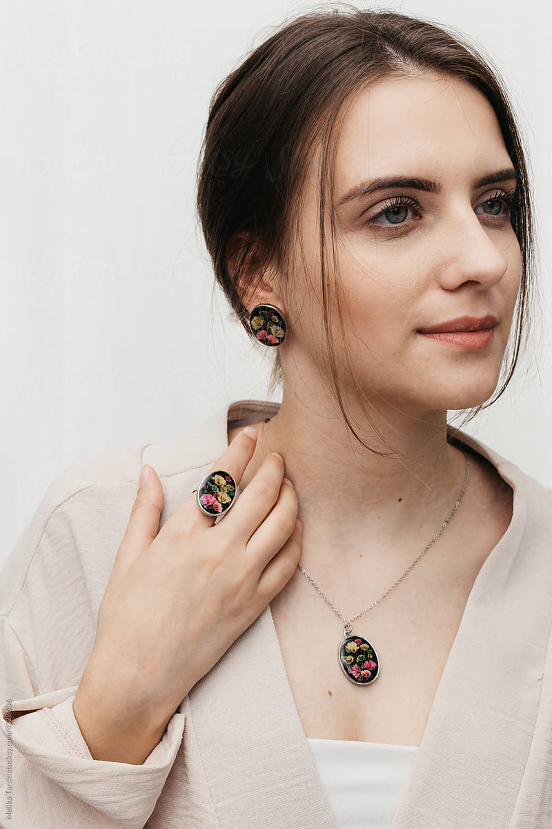 woman wearing floral epoxy necklace, earrings and ring