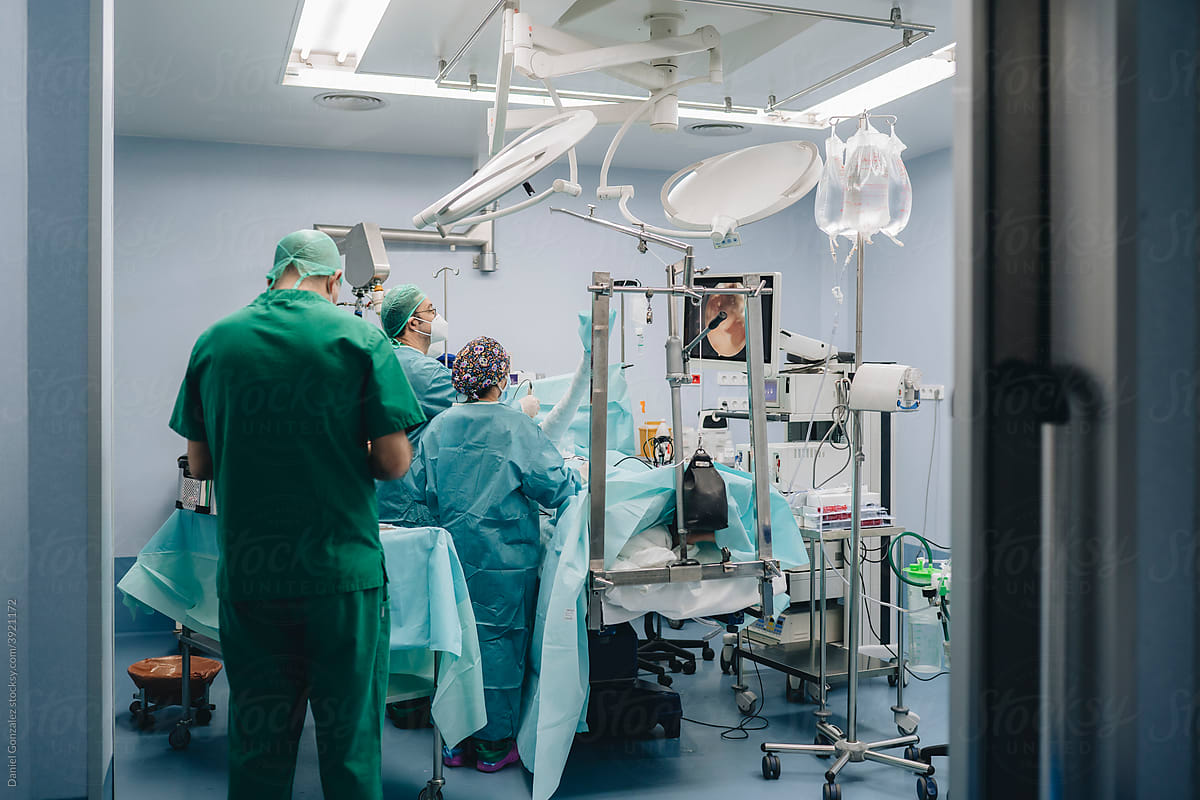 Medics providing arthroscopic surgery in hospital