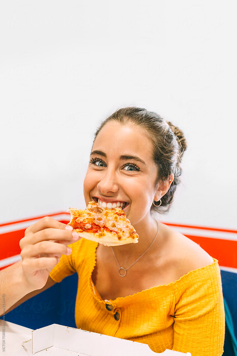 Happy Teen Girl Eating Pizza