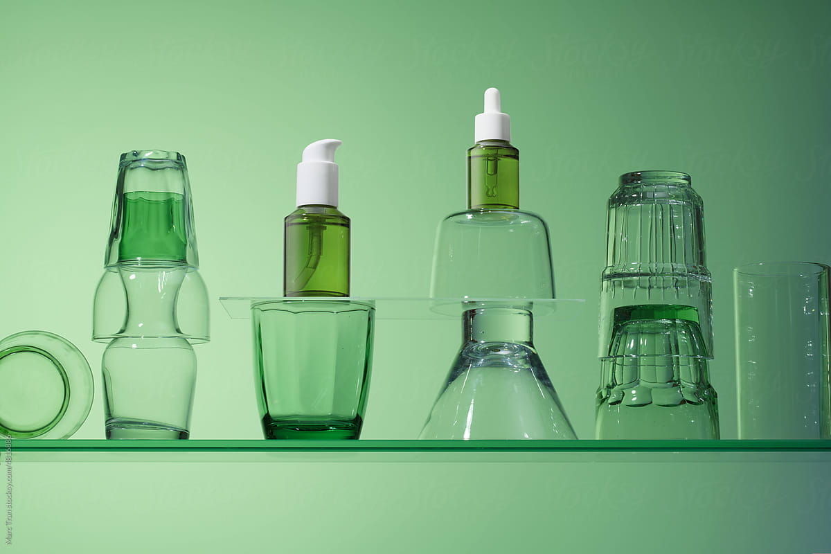 Set of beauty cosmetic products in green glass.