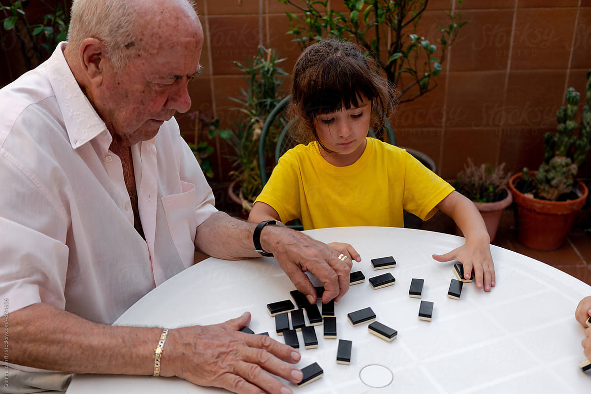 Family time playing domino with grandfather