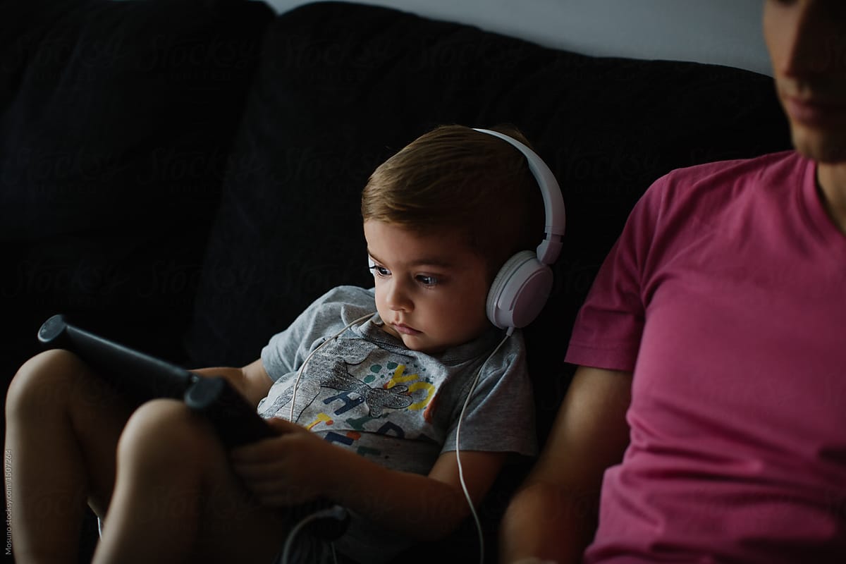 Toddler Watching Cartoons on Computer Tablet with Headset