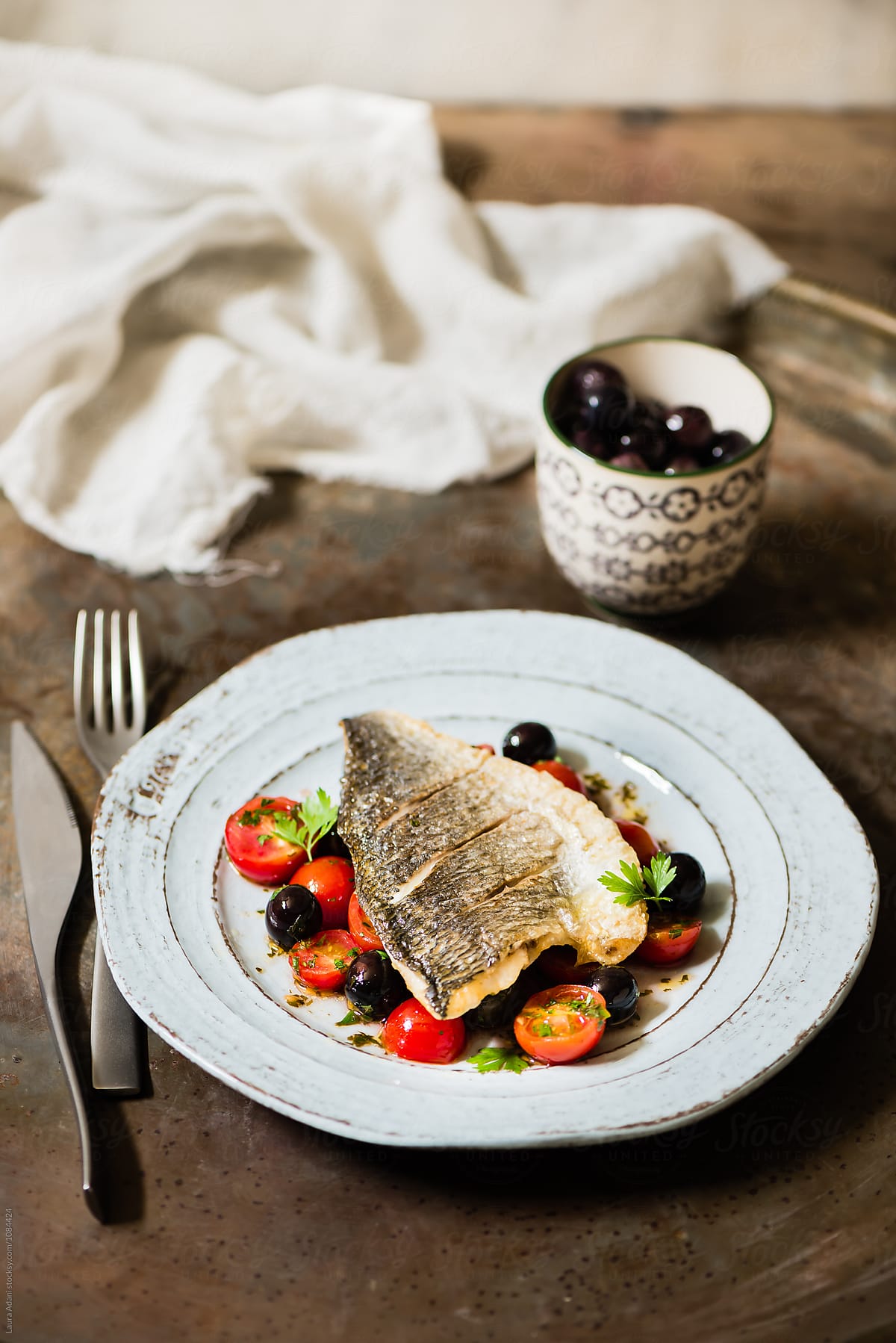 Seabream fillet with cherry tomatoes and black olives