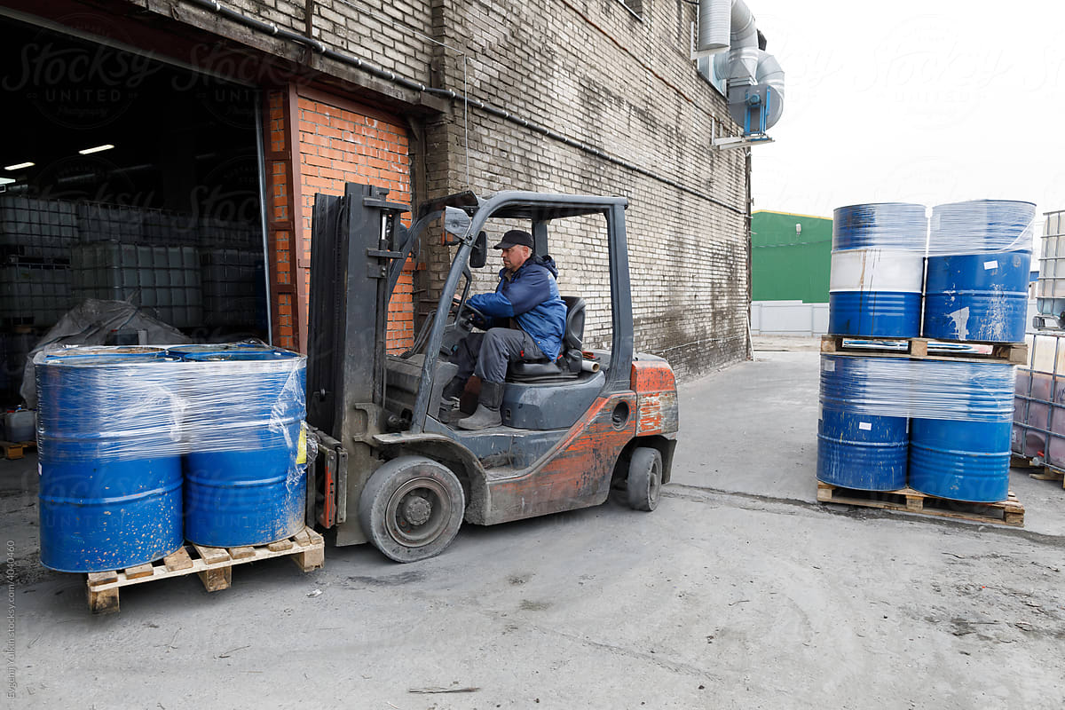 Forklift moving pallet with barrels