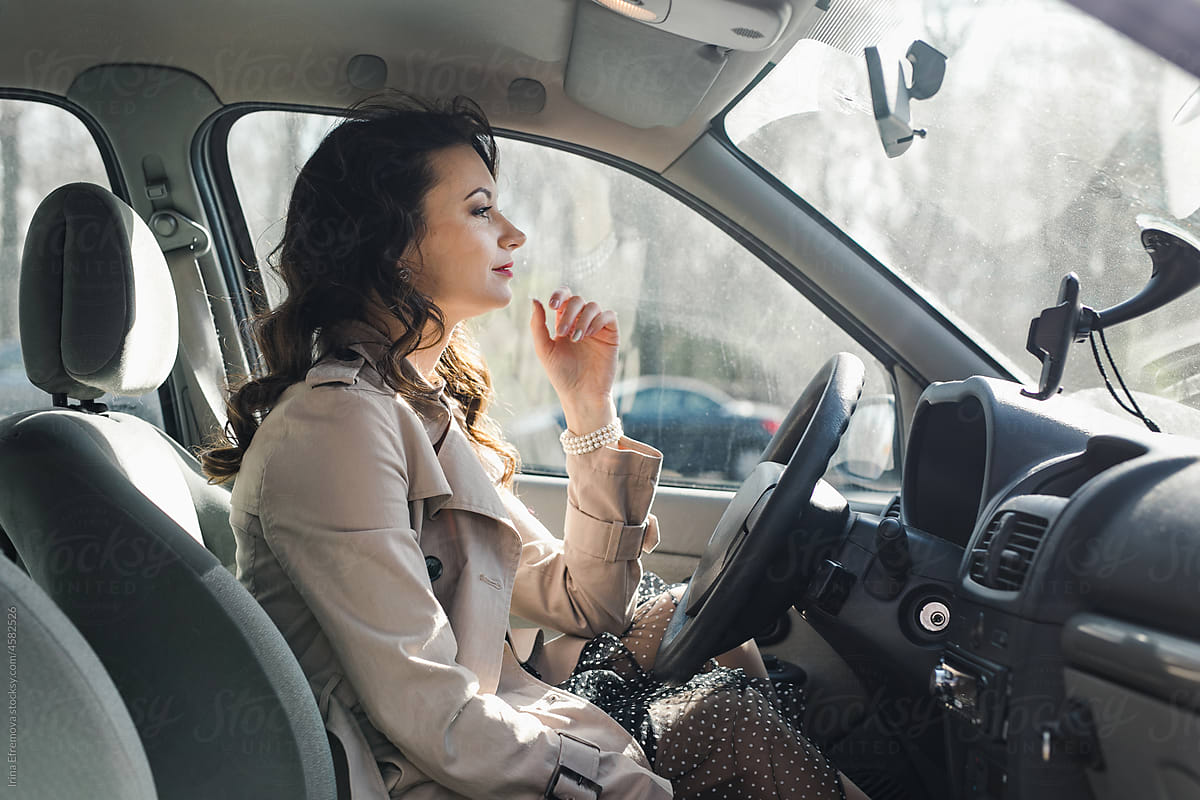 Woman in a car contemplating