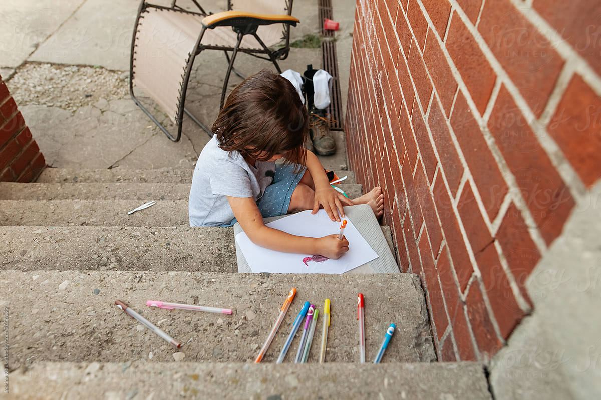 A quiet moment of 5-year-old girl drawing.