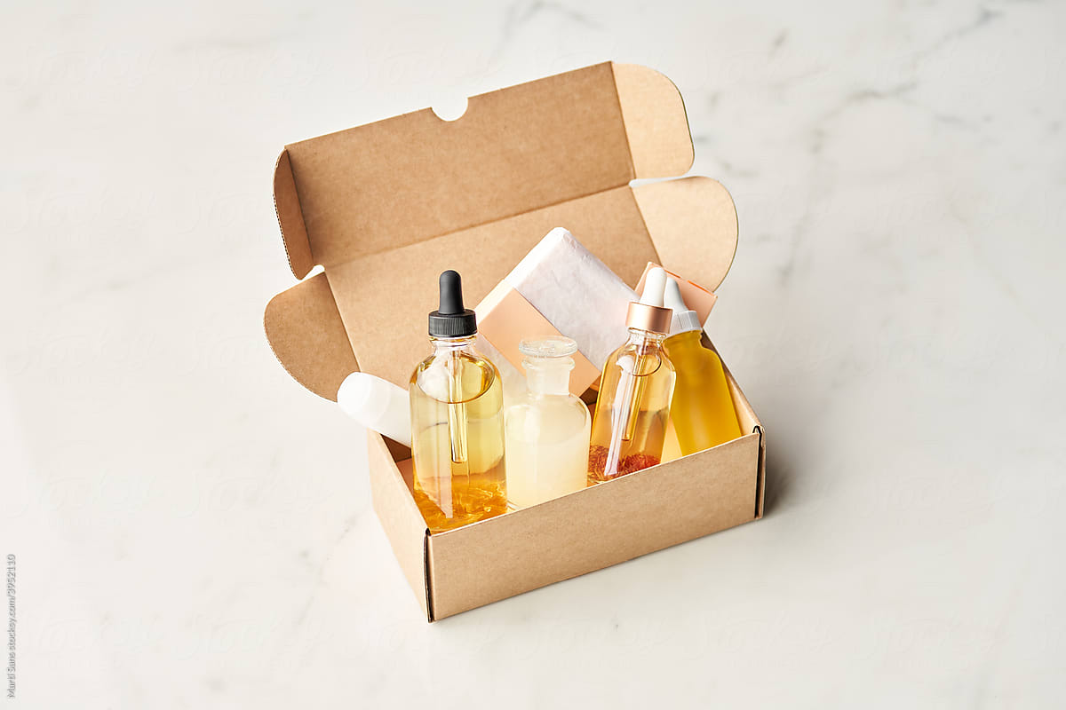 Bottles and bar of soap in beauty box.